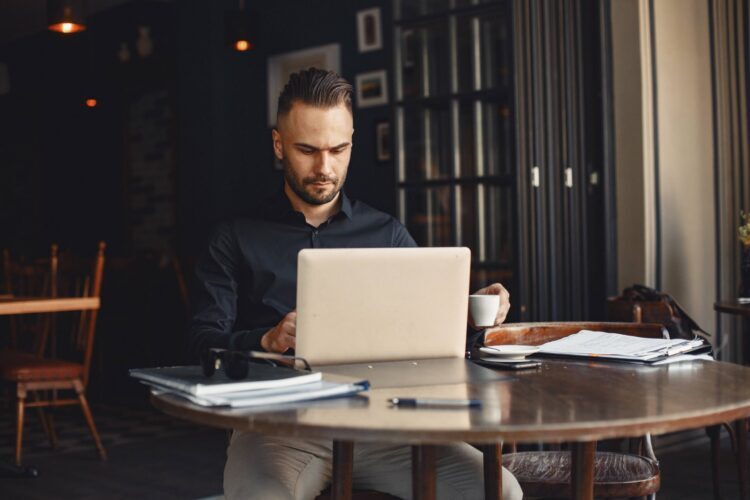 man-drinks-coffe-businessman-reads-documents-director-shirt (1)
